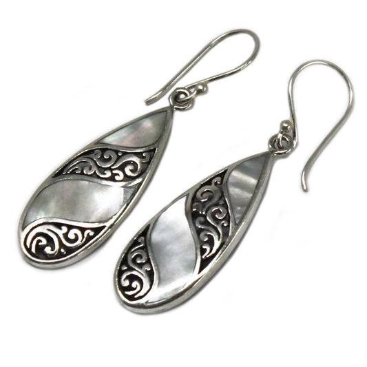 "Teardrop earrings with mother of pearl and swirling sterling silver inlay, handcrafted in Bali."