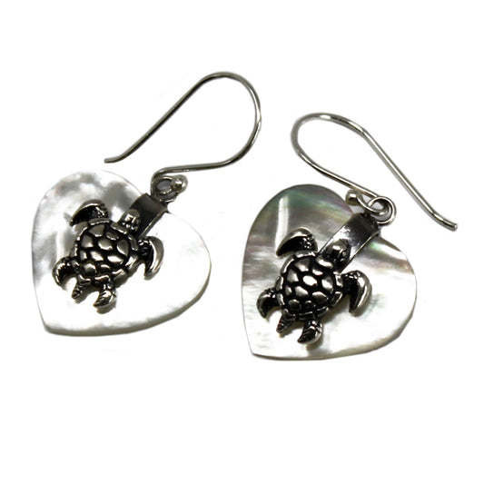 "Heart-shaped mother of pearl earrings with ornate sterling silver sea turtle overlay, handcrafted in Bali."