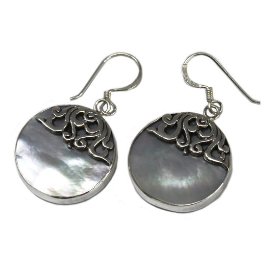 "Round mother of pearl earrings with ornate sterling silver swirl overlay and silver frame, handmade in Bali."