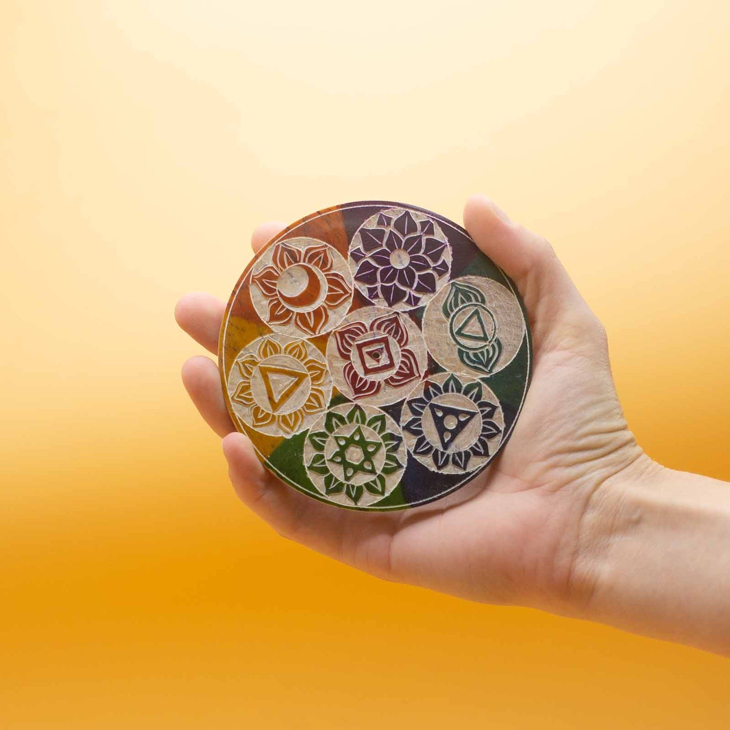 10cm soapstone incense cone holder with colorful carved Seven Chakra symbols, ideal for spiritual rituals and calming décor.