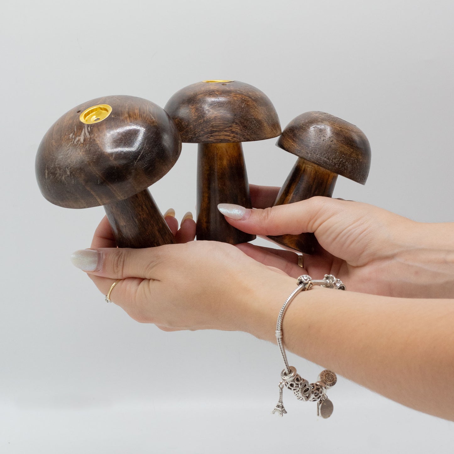 Set of 3 handcrafted mango wood mushroom incense holders in 10cm, 9cm, and 8cm sizes with brass plates for burning incense cones.