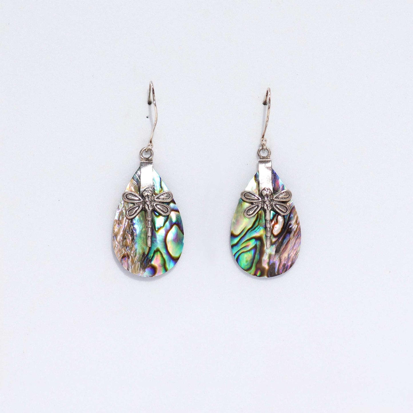 "Teardrop abalone shell earrings with detailed silver dragonfly overlay, handmade in Bali."