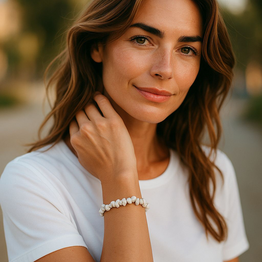 White Jasper chip stone bracelet with soft creamy stones, worn by a woman with brown hair and white shirt, symbolising peace, clarity, and emotional balance.