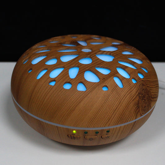 Oslo pebble-shaped USB aroma diffuser with colour-changing LEDs and timer, designed for ultrasonic misting and modern wellness spaces.