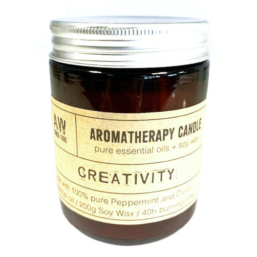 Creativity soy wax aromatherapy candle with peppermint and clove essential oils in amber jar