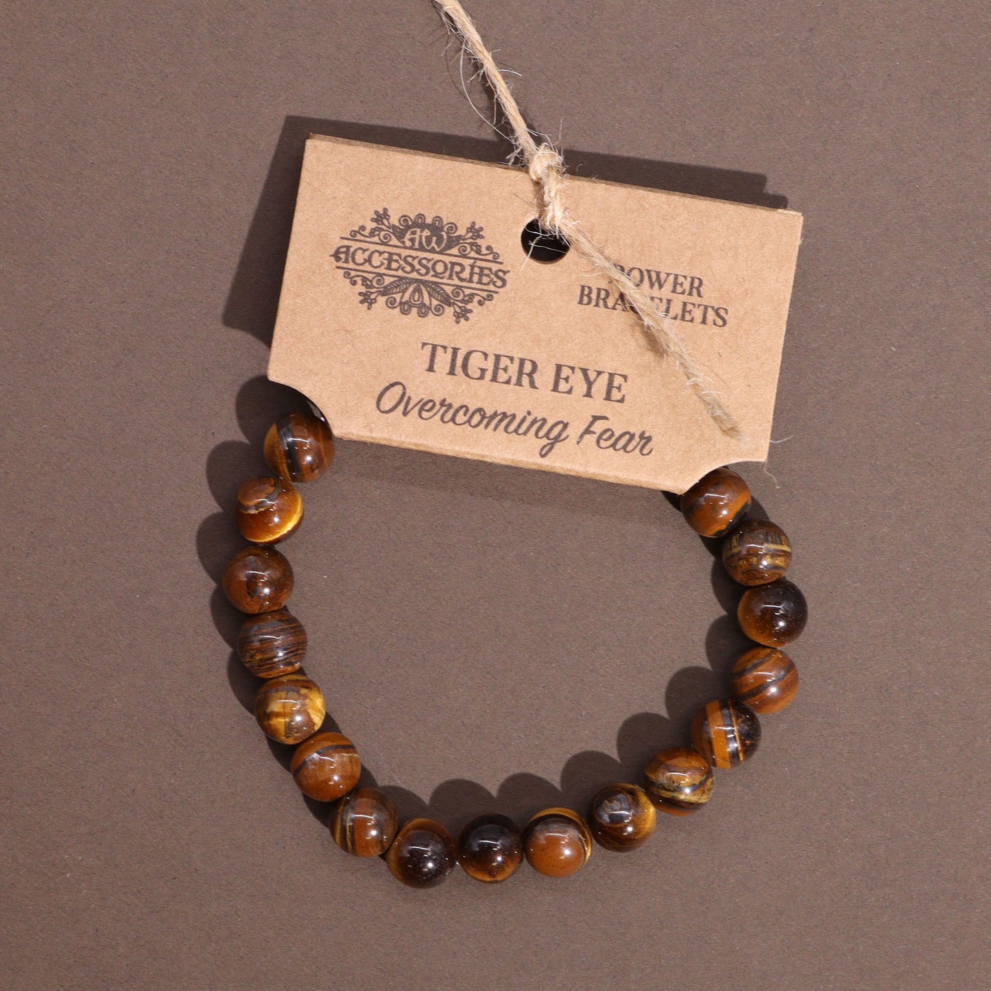 Tiger’s Eye power bracelet with golden-brown 8mm beads, symbolising courage, protection, and overcoming fear.