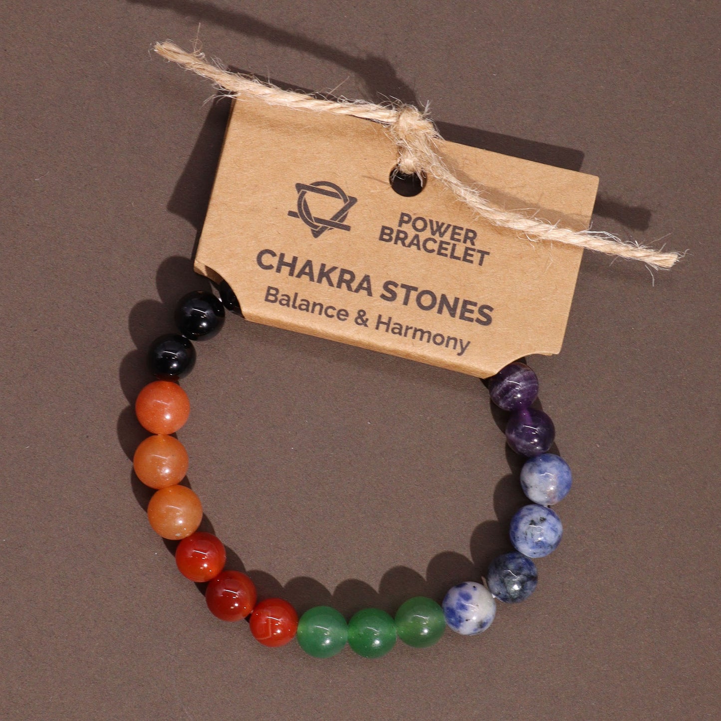 Chakra power bracelet with 7 gemstones representing the seven chakras, crafted with 8mm beads and strung on a stretch cord for energy alignment.