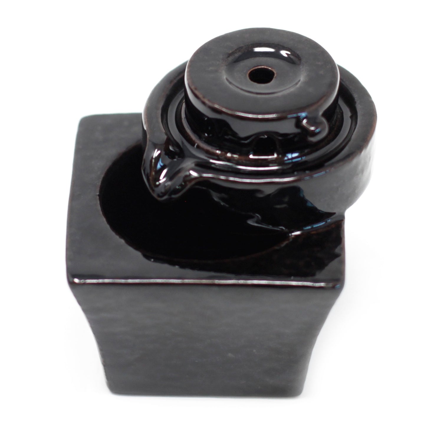 Round-to-square cascading backflow incense burner with sculpted paths for smoke flow. Modern and minimalist design for spiritual settings.