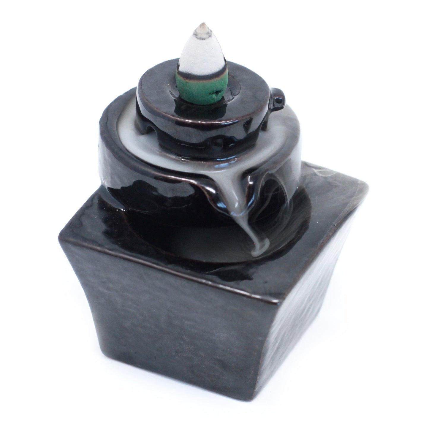 Round-to-square cascading backflow incense burner with sculpted paths for smoke flow. Modern and minimalist design for spiritual settings.