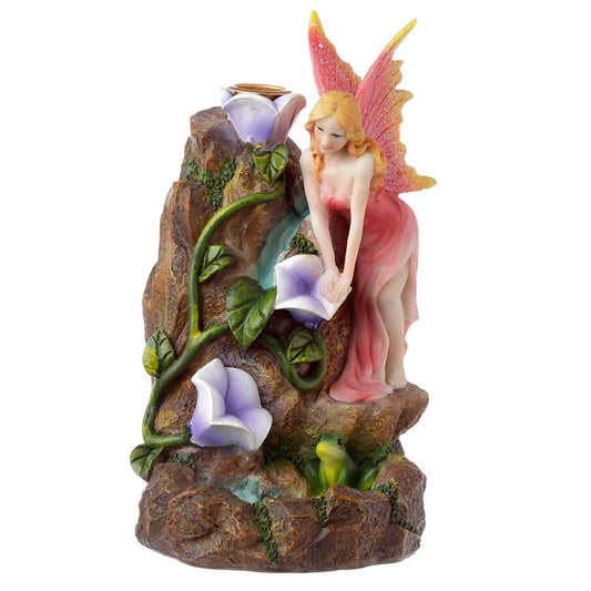 Fairy garden-themed backflow incense burner with flowing smoke, floral accents, and magical styling for fantasy-inspired interiors.