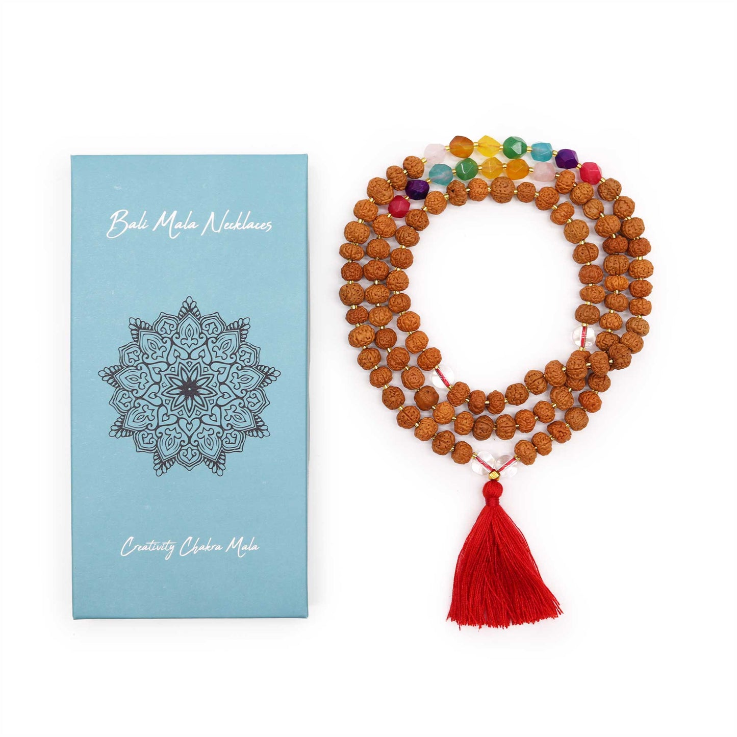 "Creativity Chakra Mala necklace with Rudraksha beads and seven chakra-coloured glass beads, finished with a bold red tassel and gift box."
