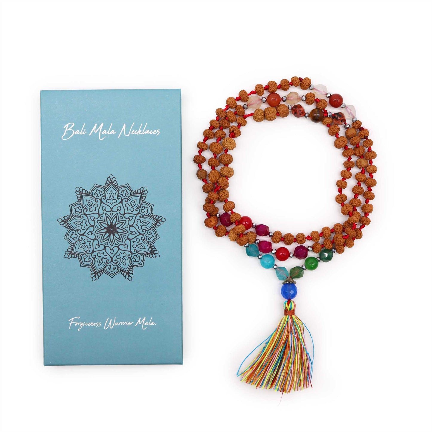 "Forgiveness Warrior Mala with Rudraksha beads, multicoloured gemstone accents, and rainbow tassel, displayed beside blue gift box."