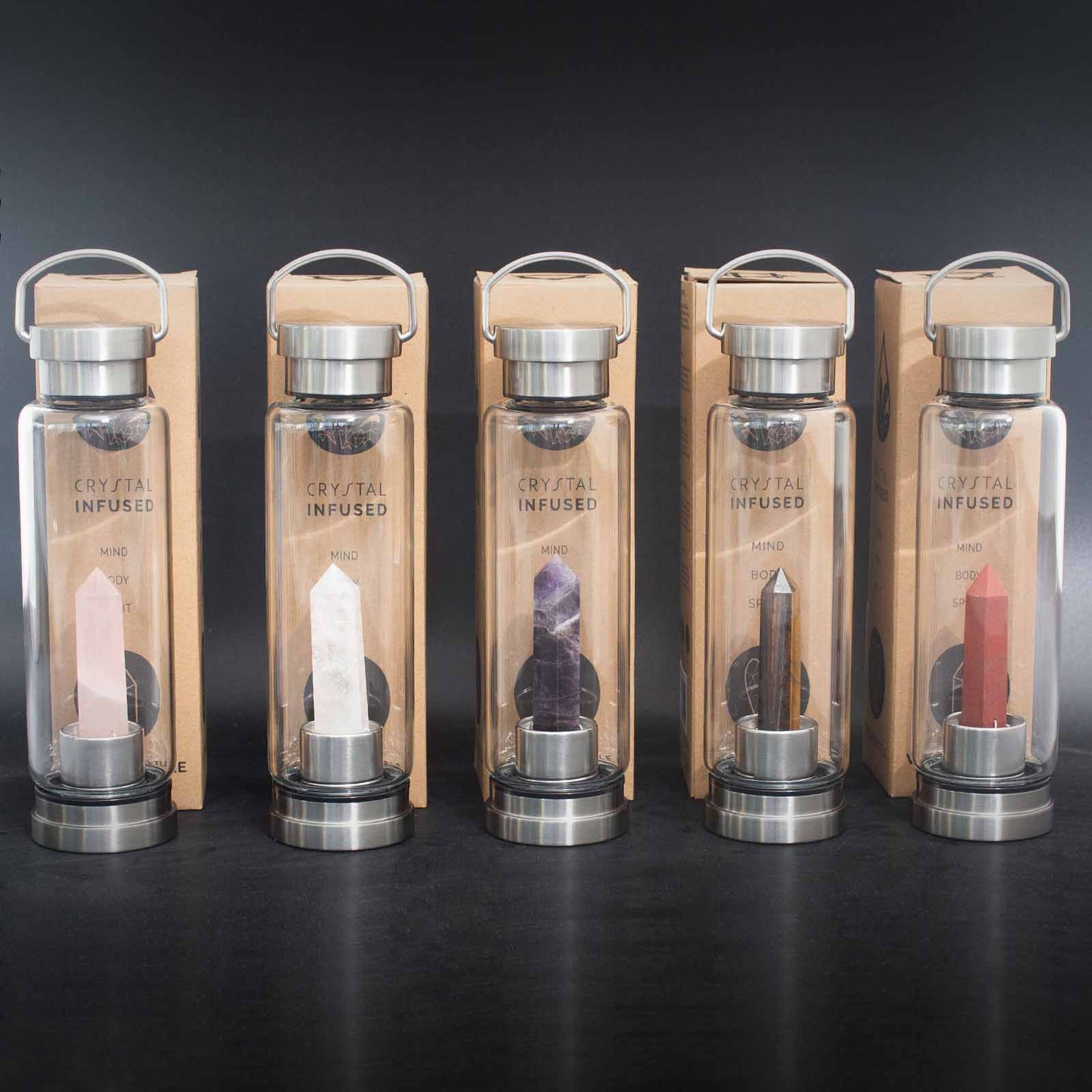 Glass water bottle with clear quartz crystal obelisk, stainless steel lid and base, neoprene sleeve, and gift box. 500ml BPA-free for clarity and energy alignment.