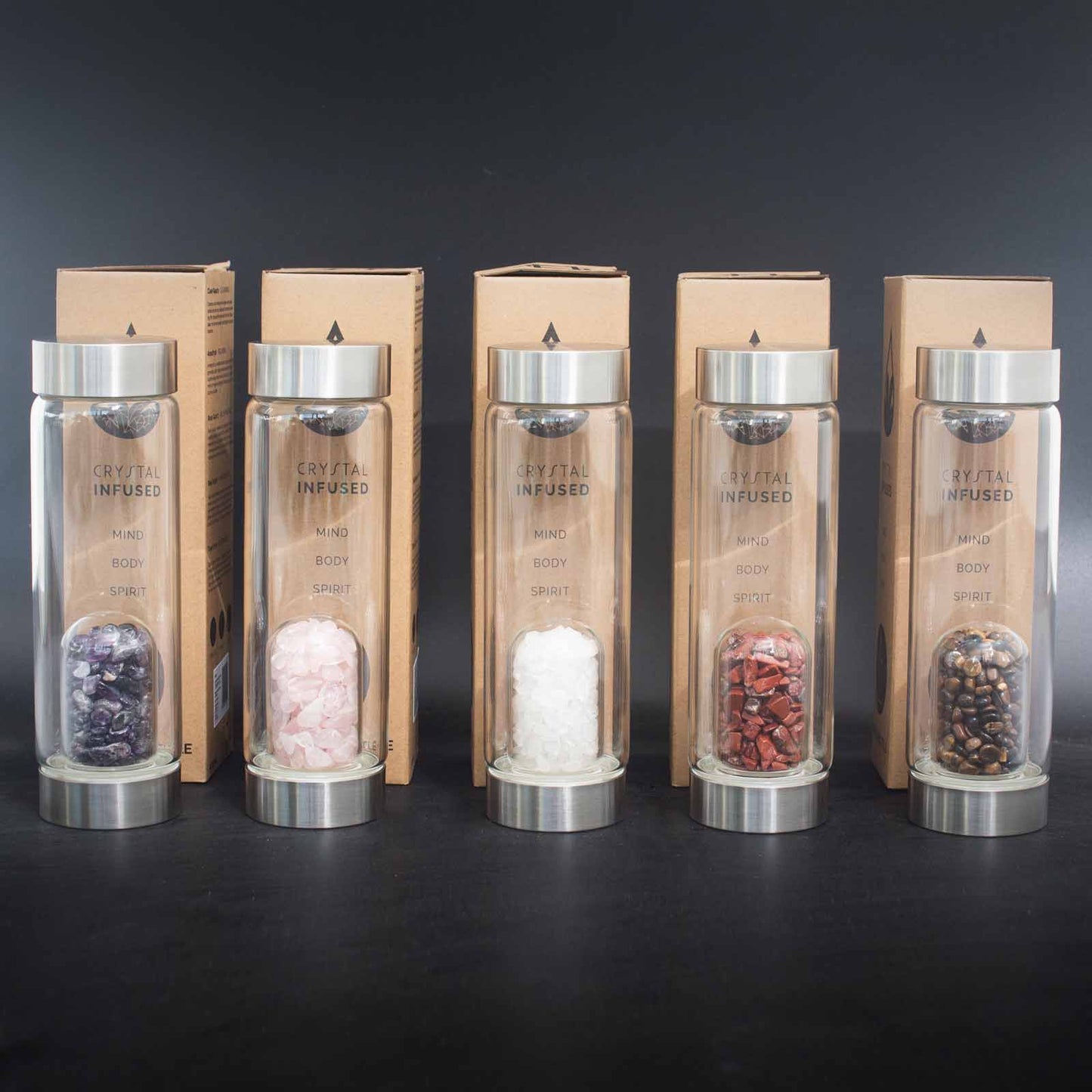 Clear quartz crystal water bottle with stainless steel cap, gemstone chip chamber, neoprene sleeve, and gift box. 500ml BPA-free bottle for energy and clarity.