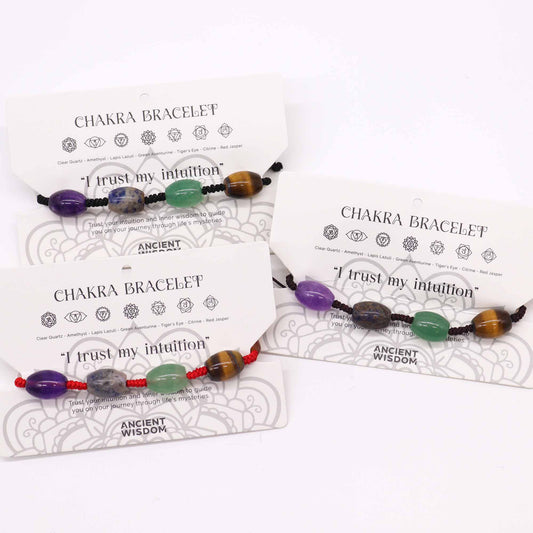 Chakra string bracelet with gemstone beads and "I trust my intuition" affirmation on an adjustable cotton cord.