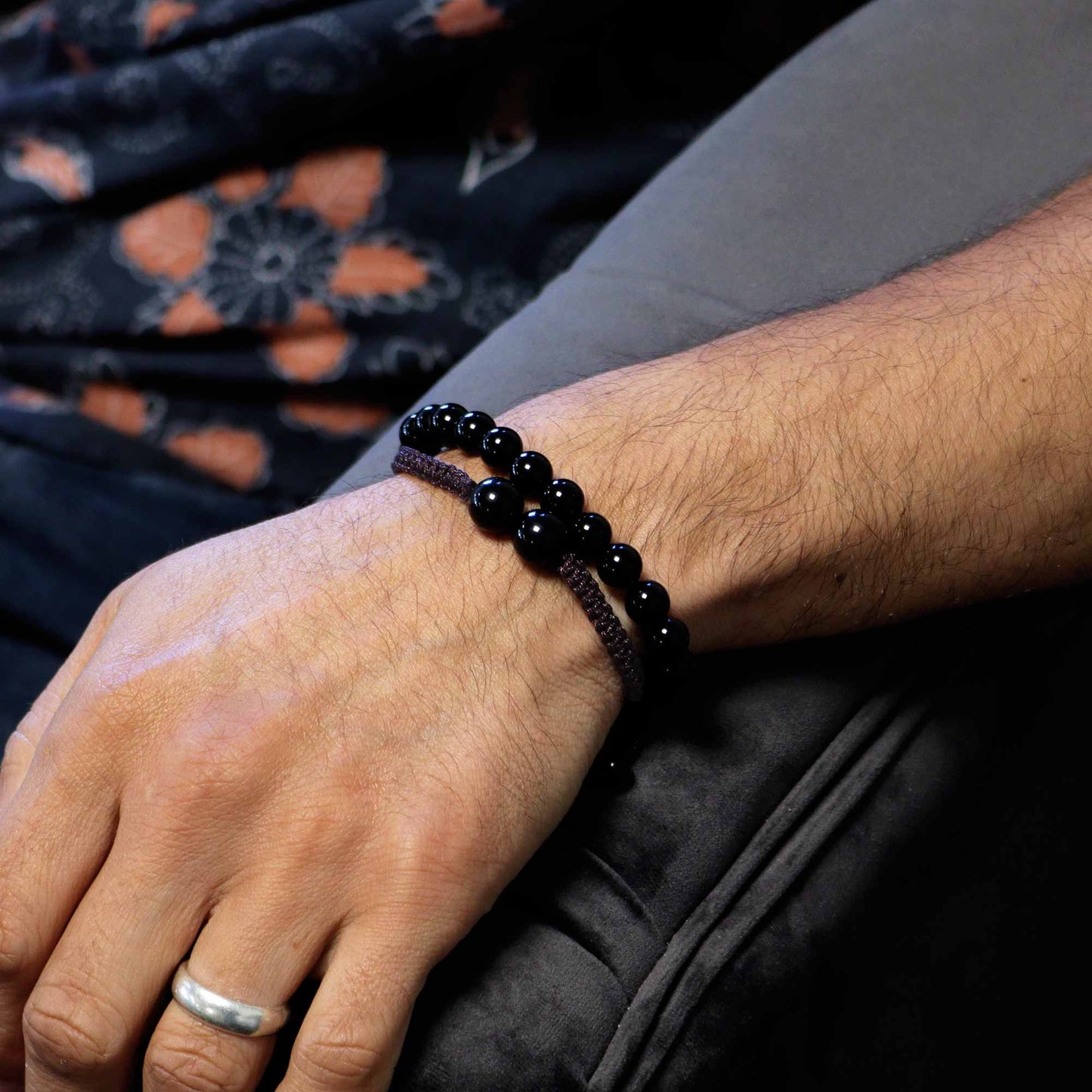 Black Agate gemstone bracelet with two large beads and “Calmness and courage” affirmation on elastic cord.