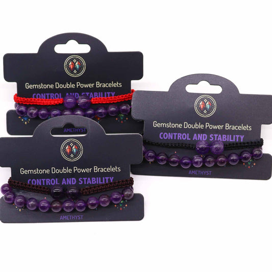 Amethyst gemstone bracelet with two large beads and “Control and stability” affirmation on adjustable elastic cord.