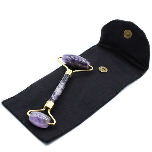 Amethyst crystal face roller with calming energy, ideal for facial massage and spiritual skincare.