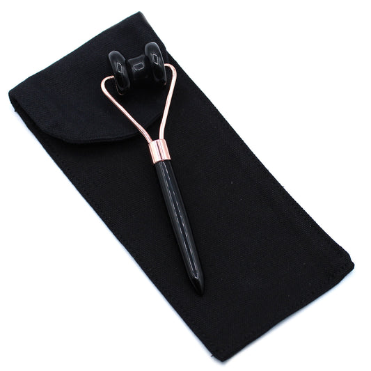 Black Obsidian jawline roller with curved head for detoxifying and sculpting facial massage.