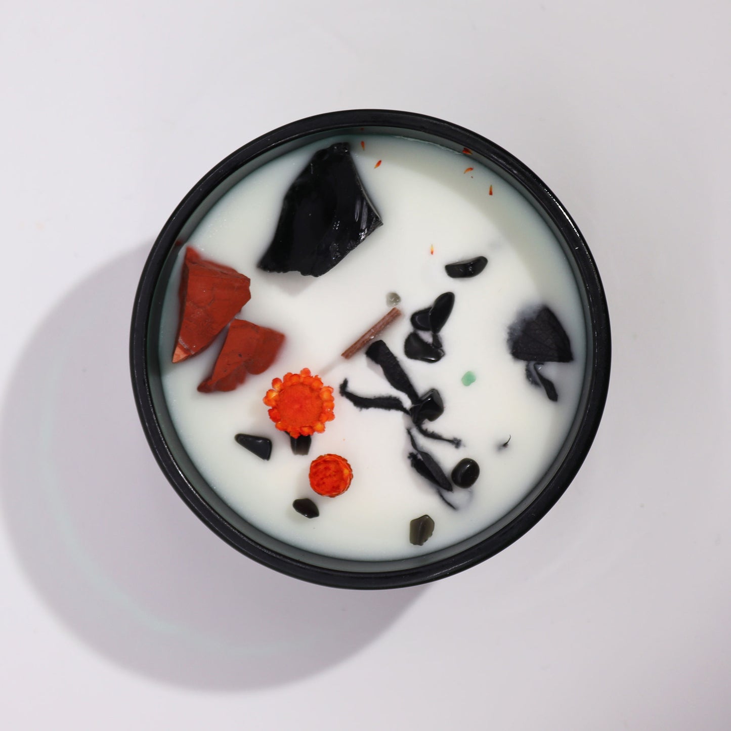 Hop Hare The Devil crystal candle with red jasper, black agate, dried flowers, and tarot card in dark green jar