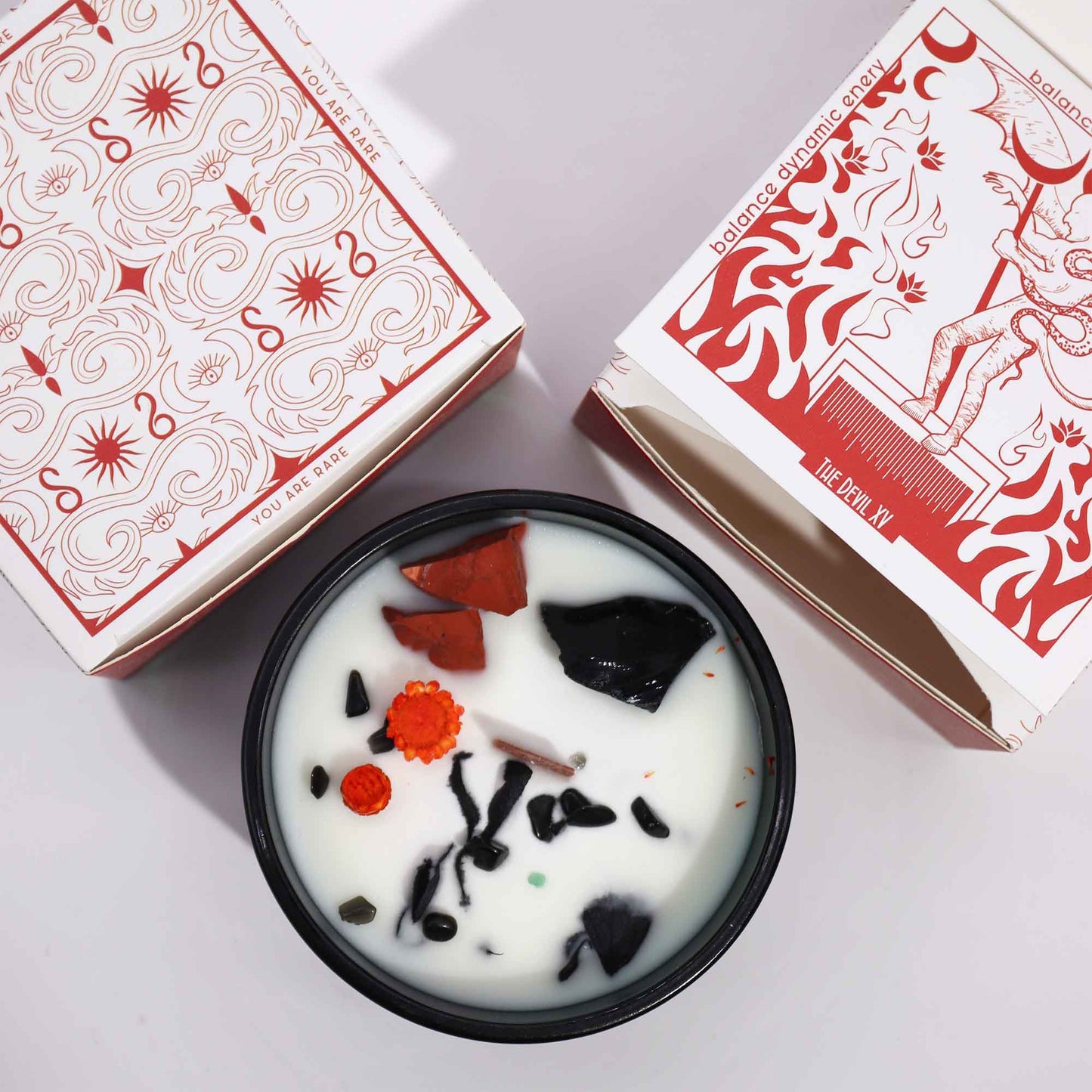Hop Hare The Devil crystal candle with red jasper, black agate, dried flowers, and tarot card in dark green jar