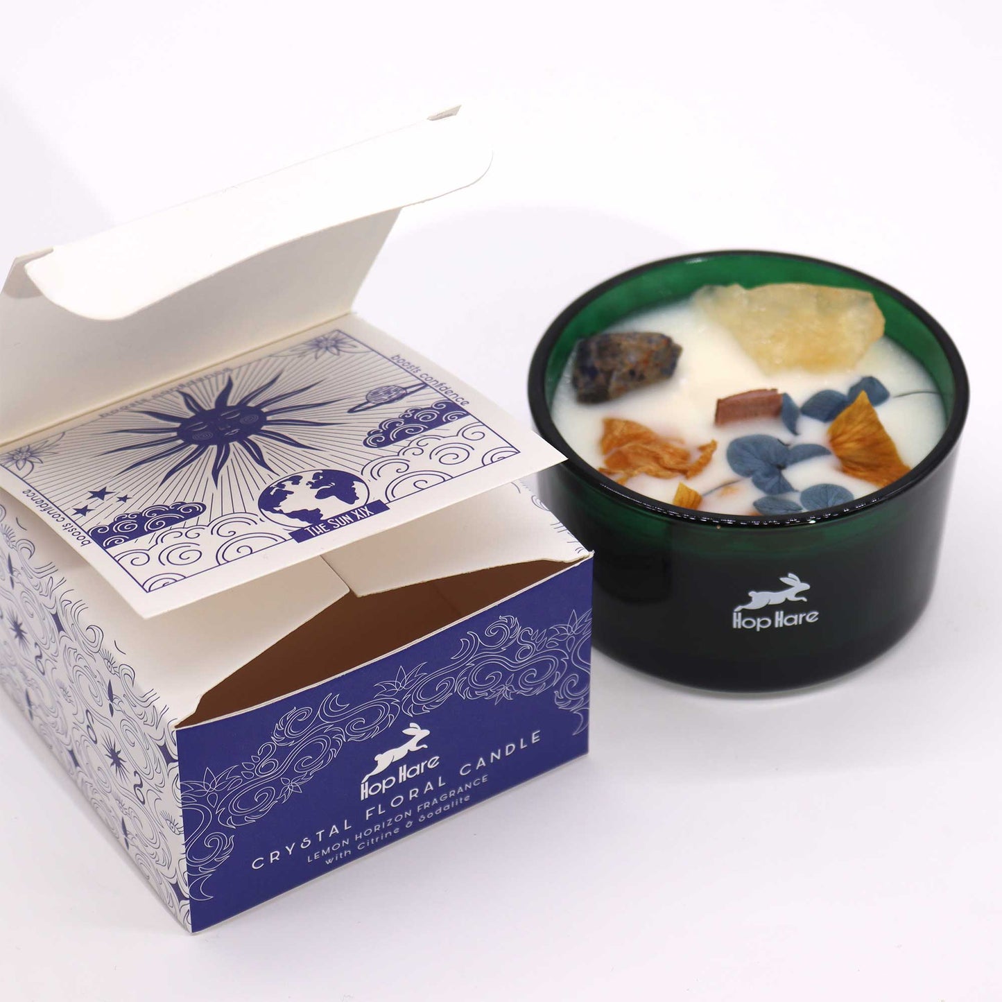 Hop Hare The Sun crystal candle with citrine, sodalite, dried flowers, and tarot card in dark green jar