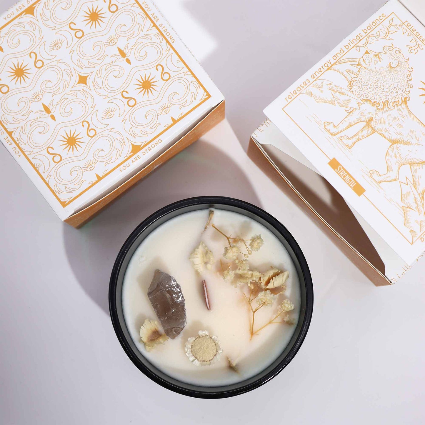 Hop Hare The Lion crystal candle with rock quartz, dried flowers, and tarot card in dark green jar