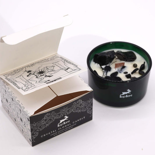 Hop Hare Knight of Swords crystal candle with black obsidian, dried flowers, and tarot card in dark green jar