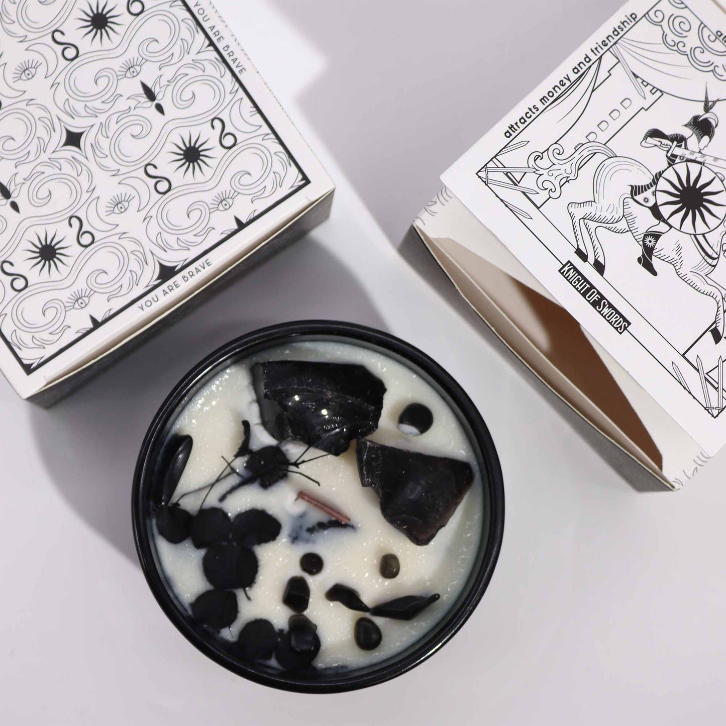 Hop Hare Knight of Swords crystal candle with black obsidian, dried flowers, and tarot card in dark green jar