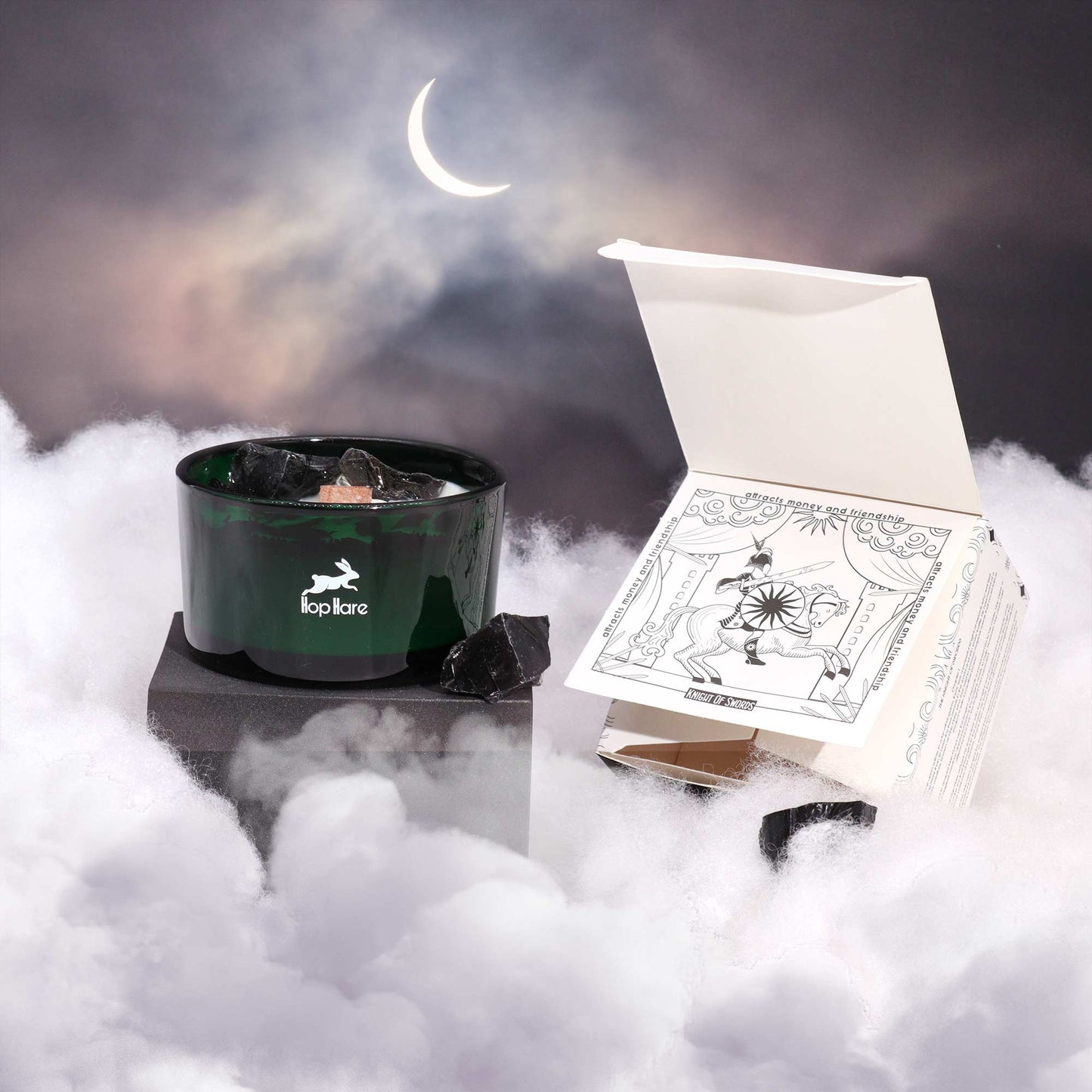 Hop Hare Knight of Swords crystal candle with black obsidian, dried flowers, and tarot card in dark green jar