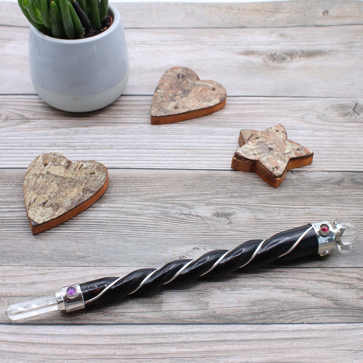 Twisted wooden wand with rock quartz point and sphere, silver plated copper wire, and gemstones. Designed for clarity, energy amplification, and healing.