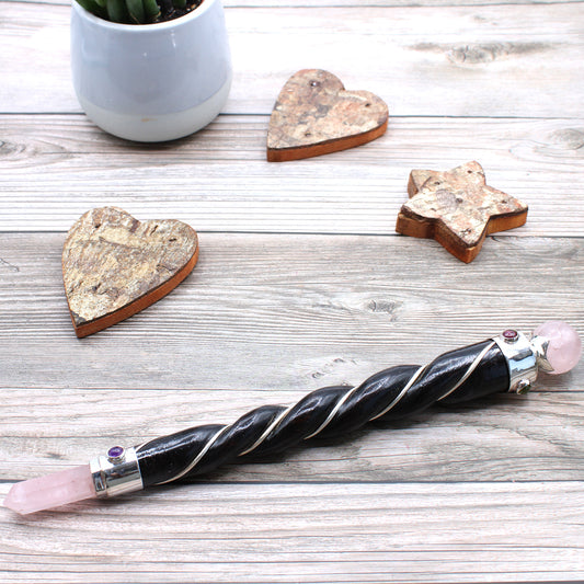 Twisted wood healing wand with rose quartz point and sphere, silver plated copper wire, and gemstones. Ideal for love, compassion, and emotional healing.