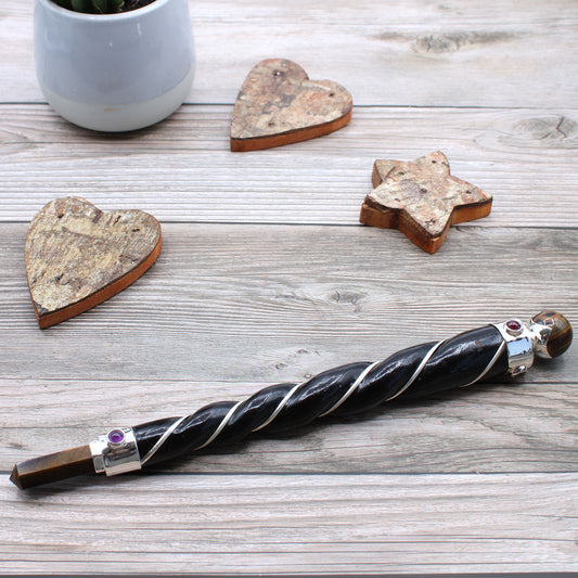 Twisted wooden healing wand with silver plated copper wire, tiger’s eye point and sphere, and gemstone accents. Ideal for grounding and energy alignment.