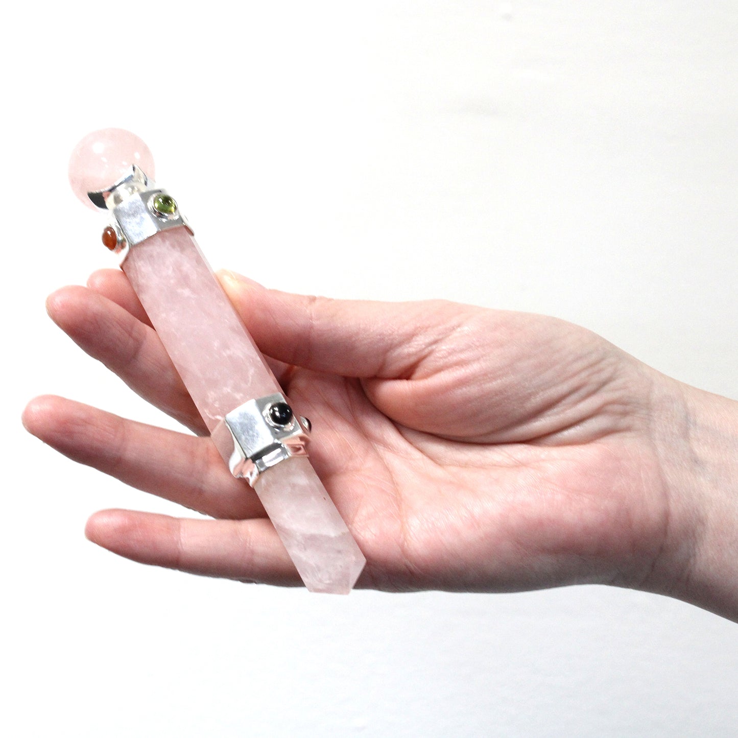 Hexagonal rose quartz healing wand with pointed tip, rounded sphere end, and gemstone accents. Ideal for love, emotional healing, and chakra alignment.