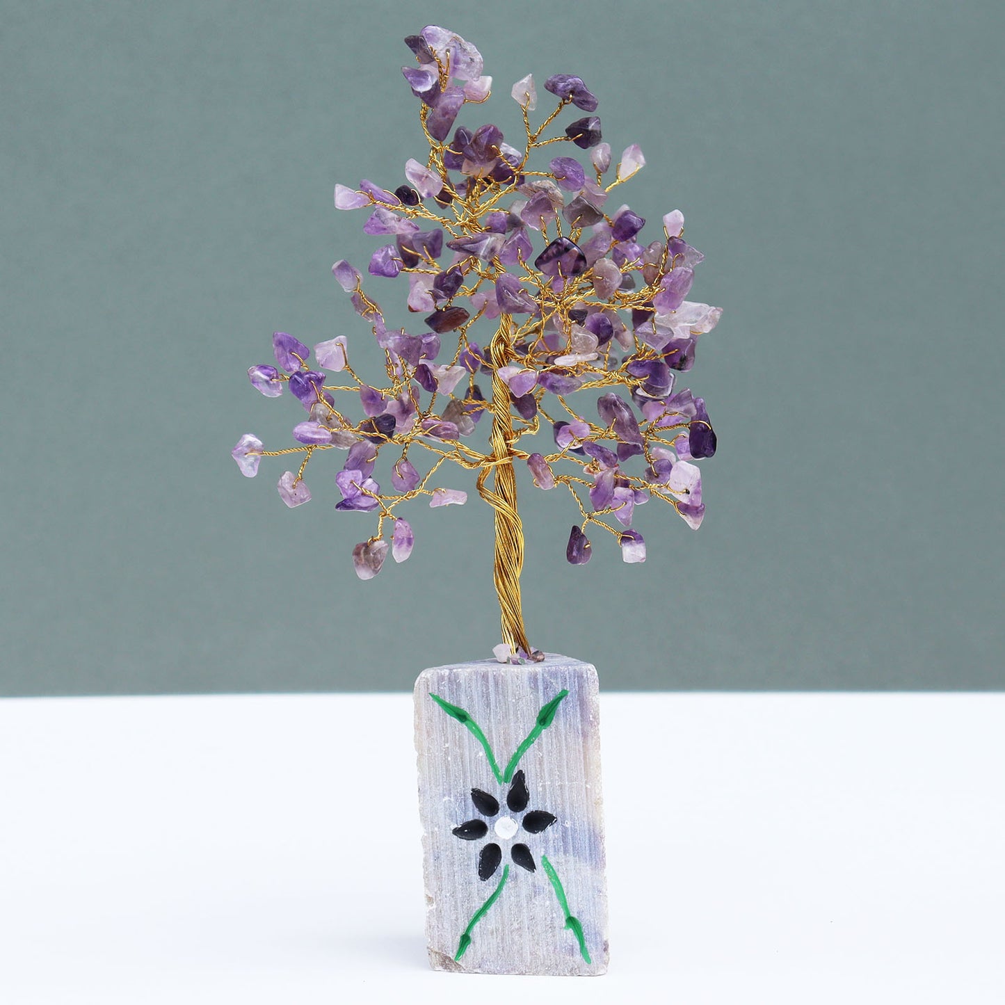 Amethyst crystal tree with hand-carved base