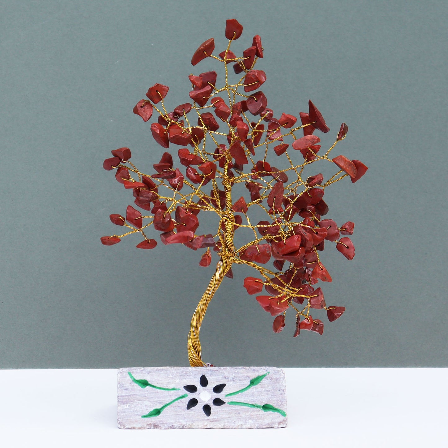 Red jasper crystal tree with carved stone base