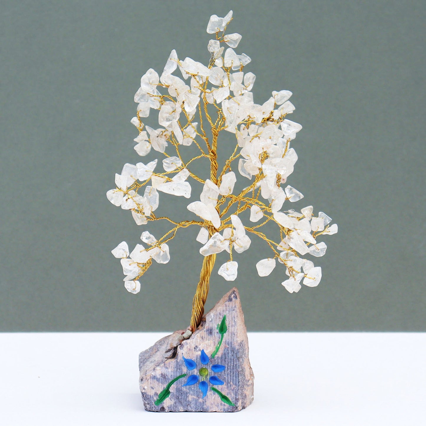 Rock quartz crystal tree with carved stone base