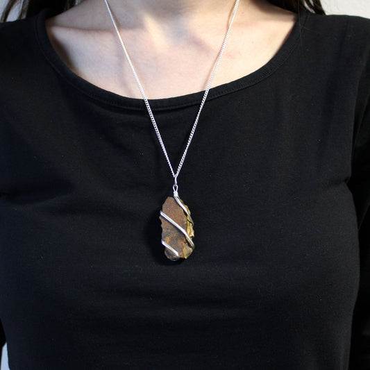 Raw Tiger’s Eye gemstone pendant with silver-toned cascading wire wrap