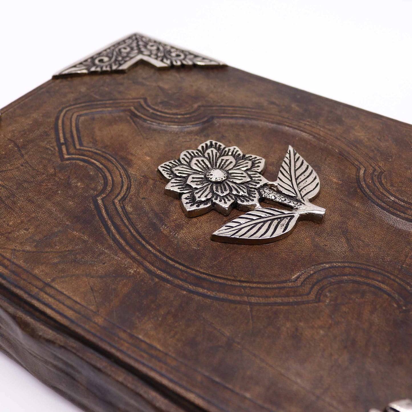 Leatherbound journal with zinc rose emblem and ornate metal corner designs