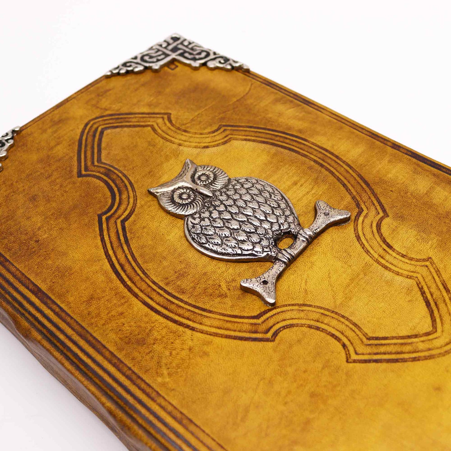 Leatherbound journal with embossed owl and zinc corners – cover view