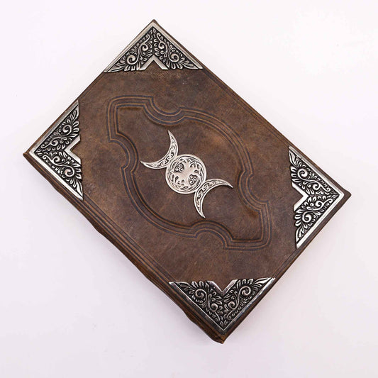 Leatherbound journal with triple moon zinc symbol and embossed corners – 200 deckle-edge pages.