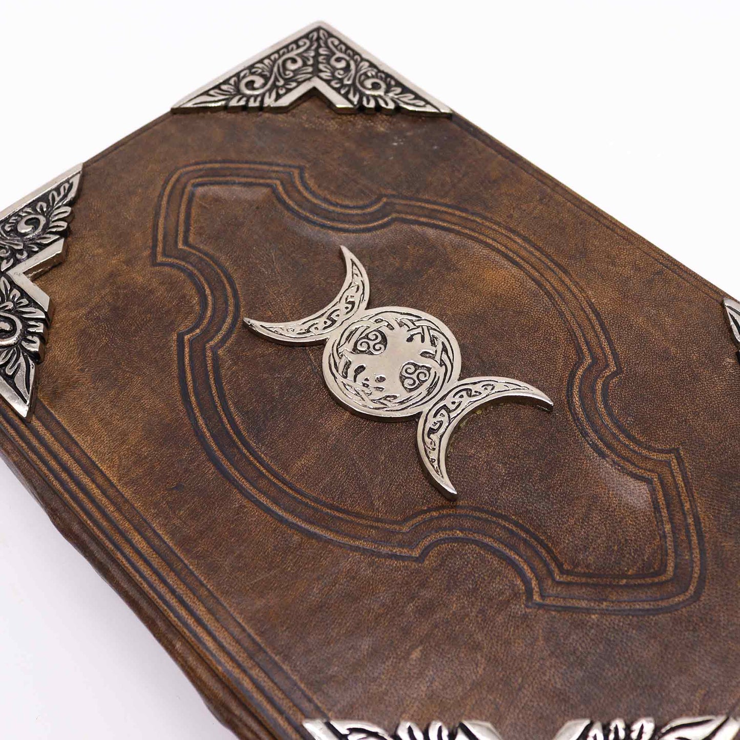 Leatherbound journal with triple moon zinc symbol and embossed corners – 200 deckle-edge pages.