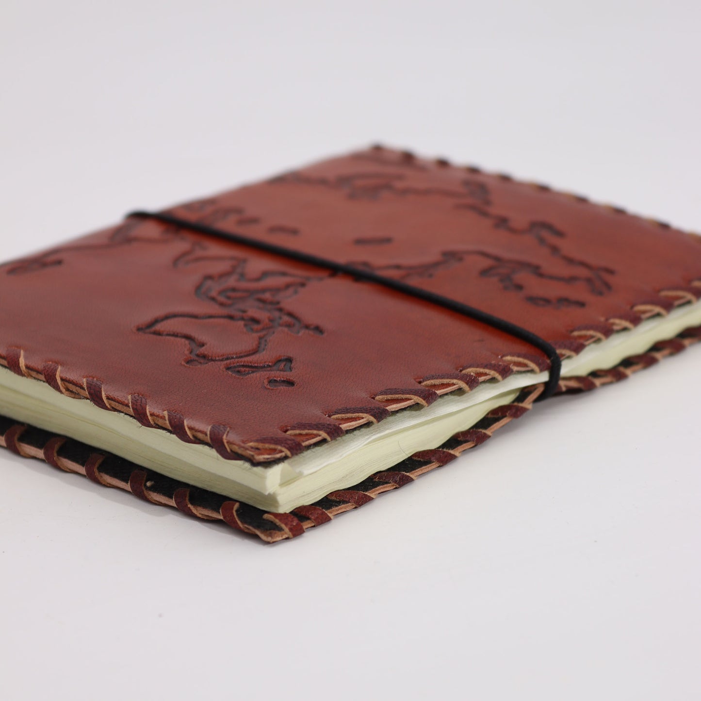 Red leather travel journal with world map embossing and wrap closure – 96 pages