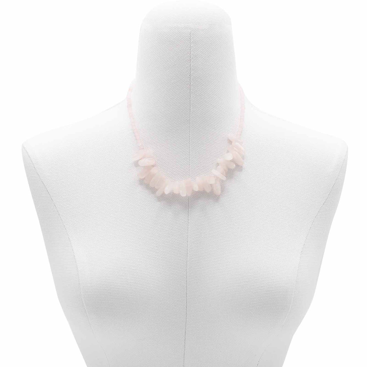 "Longstone Gem Necklace with rose quartz gemstone chips and round beads in soft blushing pink, displayed on a jewellery bust."
