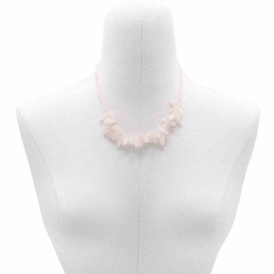 "Longstone Gem Necklace with rose quartz gemstone chips and round beads in soft blushing pink, displayed on a jewellery bust."
