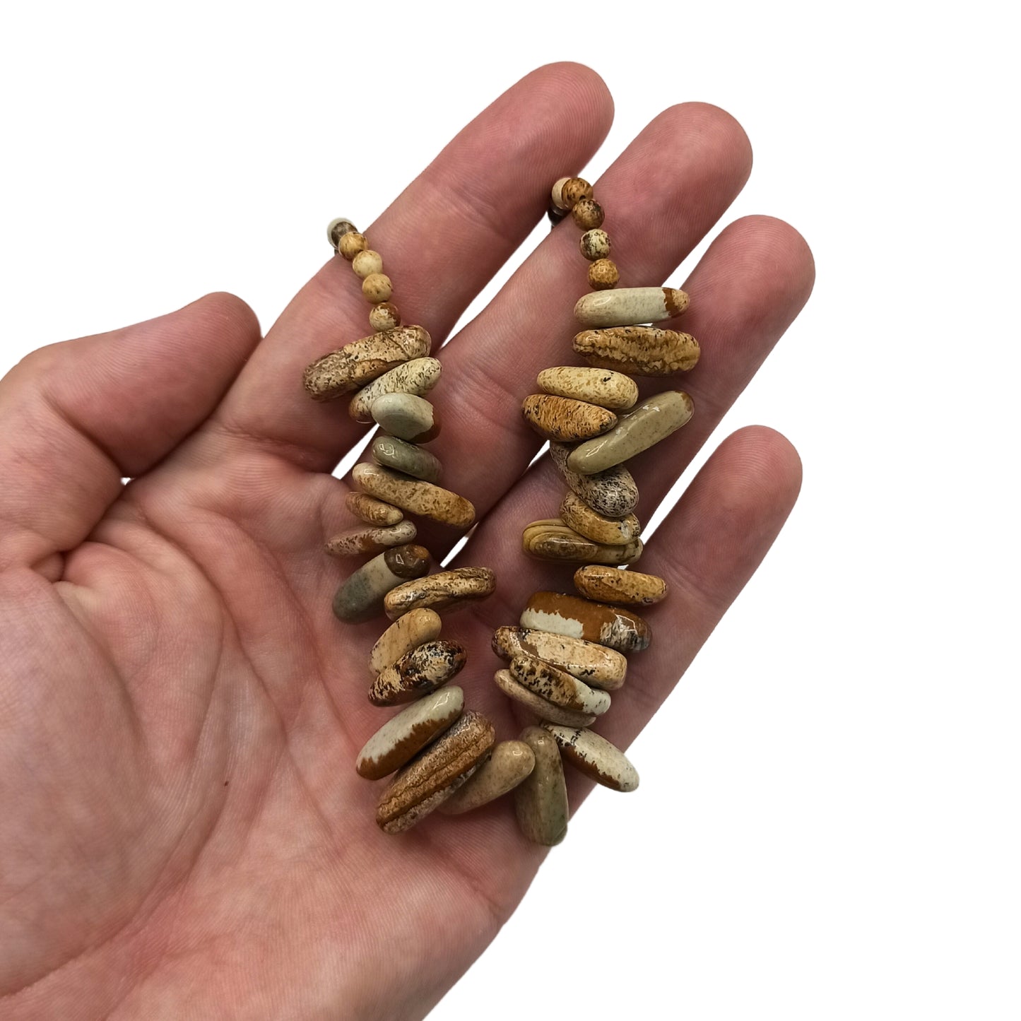 "Longstone Gem Necklace with Map Stone gemstone chips and round beads featuring earthy brown and tan markings, displayed on hand."
