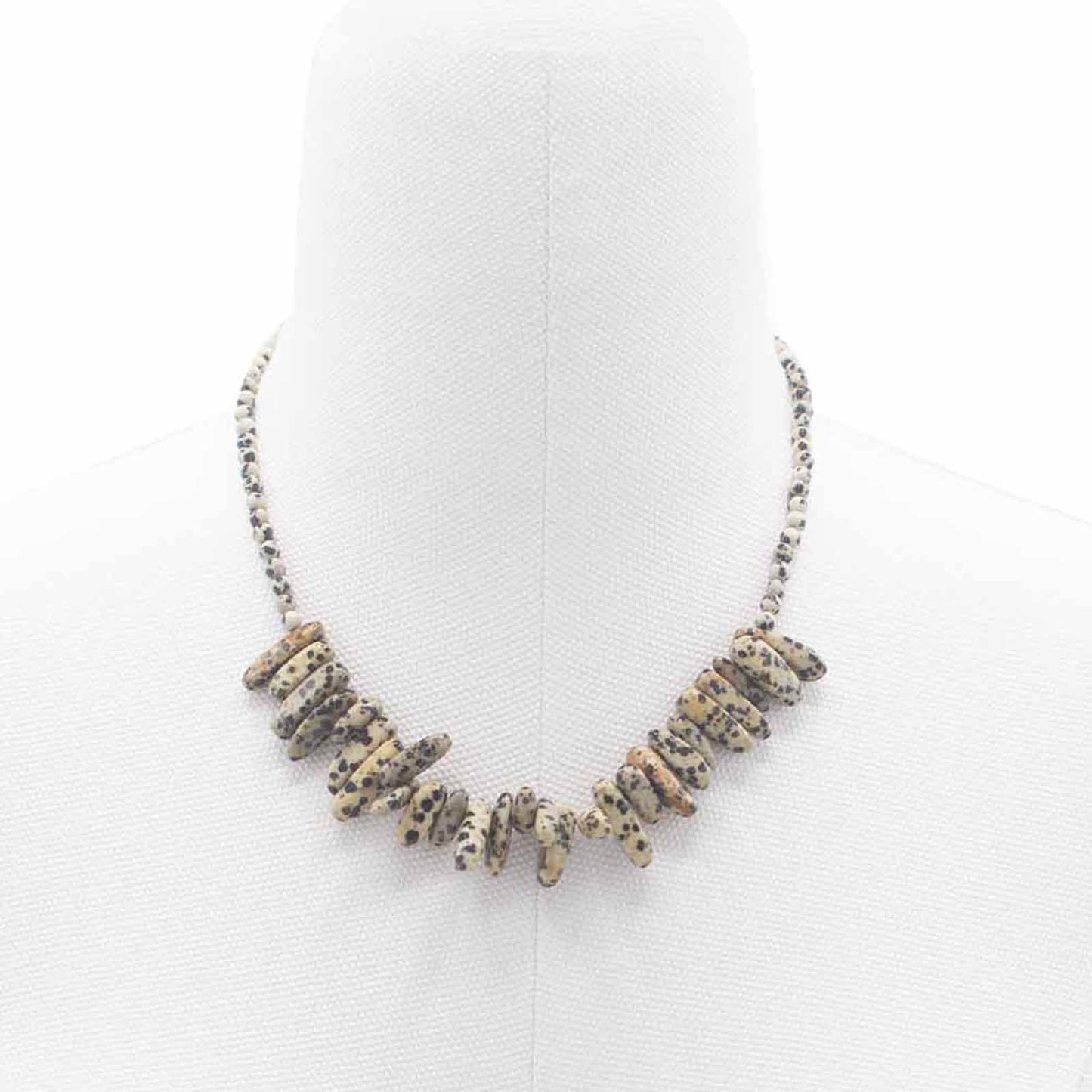 "Longstone Gem Necklace with Dalmatian Stone gemstone chips and round beads featuring natural black spots on a cream base, styled on a white display stand."