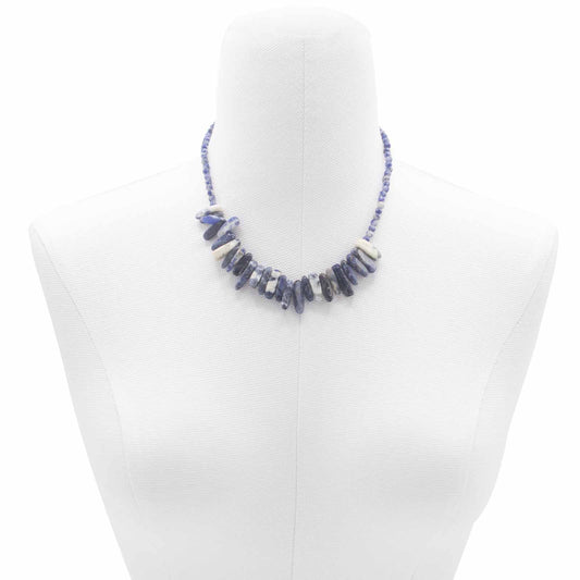"Longstone Gem Necklace featuring deep blue sodalite gemstone chips and matching round beads, displayed on a white bust."