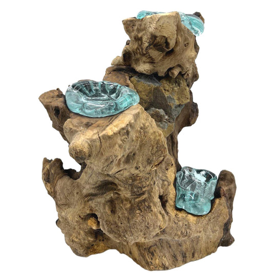 Molten glass and wood three candle holder with hand-poured tealight vessels resting on natural Balinese Gamal wood.