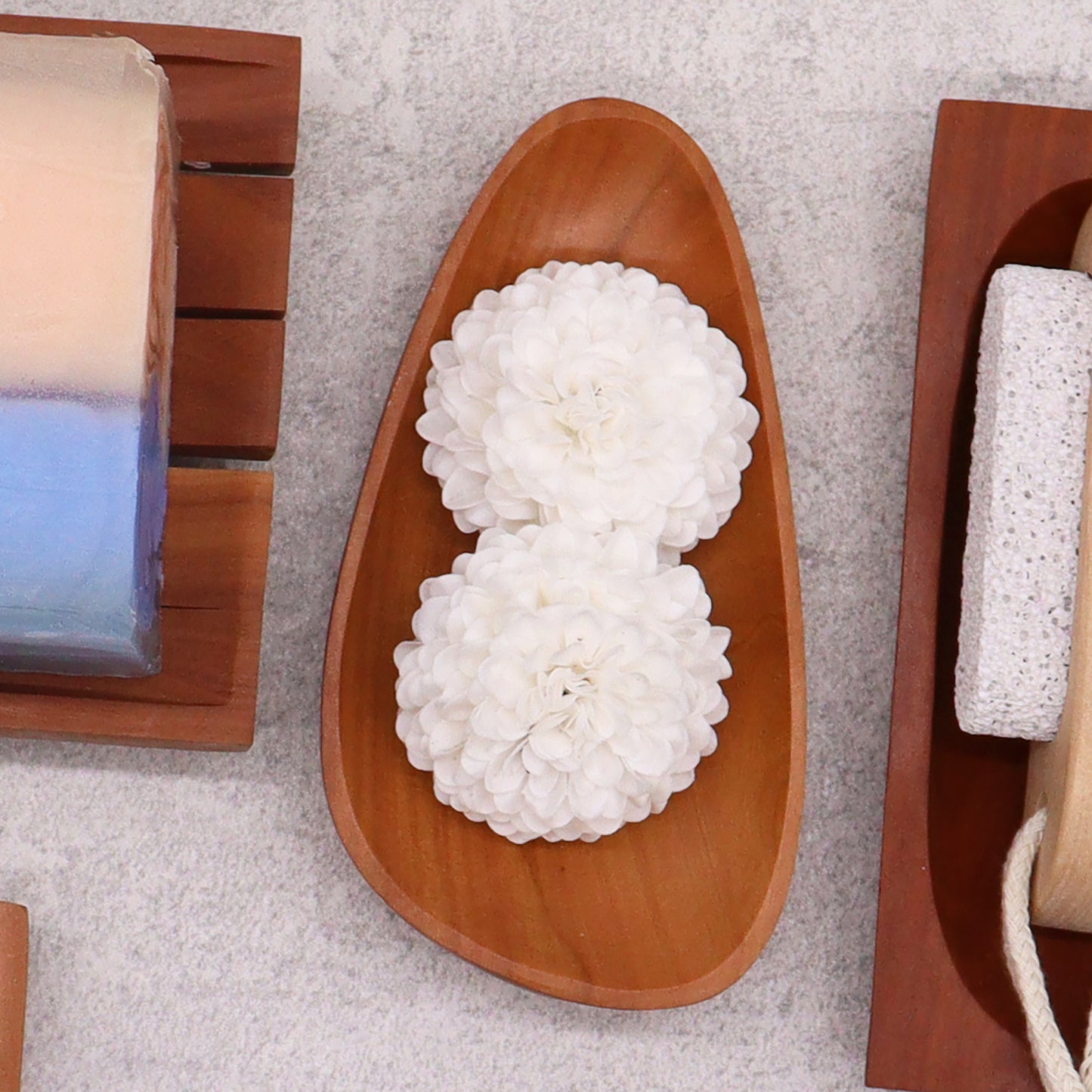 Pebble shaped mahogany soap dish with drainage holes